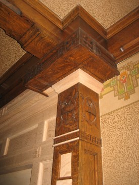 Drawing on details from elsewhere in the room, cabinetmaker Jon Frost created a&nbsp;new white oak over-mantle.&nbsp;Intricate molding surrounds the fireplace that was faithfully restored using original details as a guide.