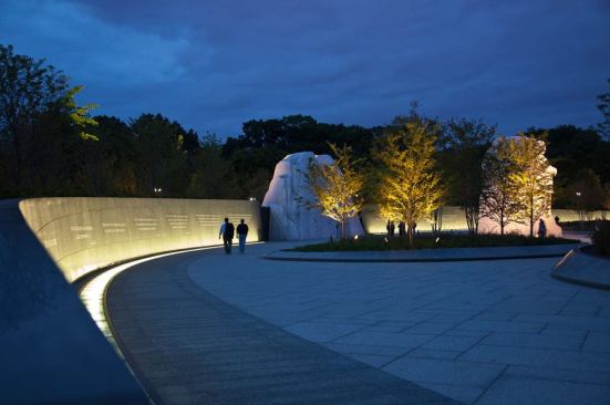 A view of the site at night with the Inscription  Wall to the left and the granite block, the Mountain of Despair and the Stone  of Hope, in the distance.