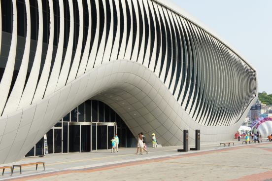 The 108 lamellas open to allow natural light inside the pavilion. A curtainwall stands behind the kinetic façade on the pavilion's east elevation.