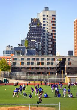 View of south fa&ccedil;ade showing solar array and connection to community.