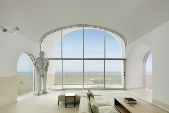 The double-height living room window is visible throughout the house.