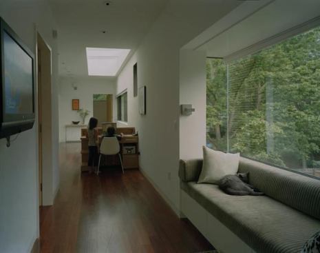 A steel box-frame window on the second story of this suburban remodel offers space for an inset bench that serves as a perch for observing&nbsp; goings on indoors and out.  Residential Architect, May-June 2010  
L-Stack House, Fayetteville, Ark.  Marlon Blackwell Architect, Fayetteville, Ark.