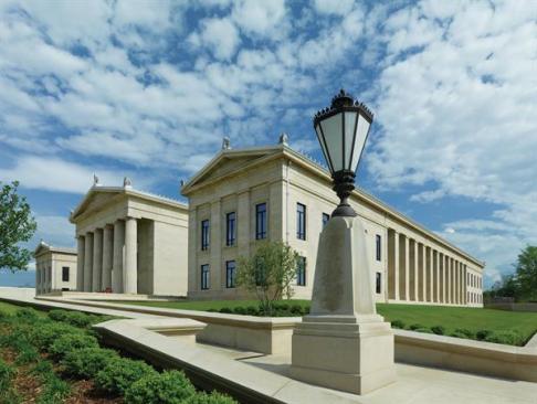 The acroteria that mark the angles of each pediment use classical detailing but were designed to work in concert with the building?s brushed-aluminum roof.