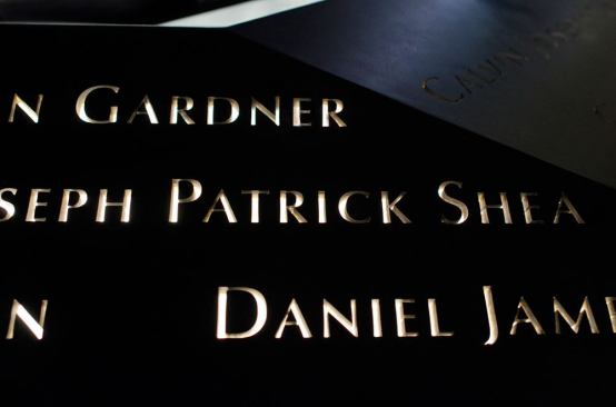 Narrow-profile 3500K LED luminaires backlight the names of the victims.