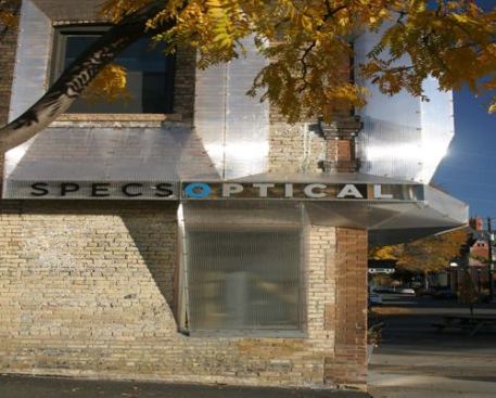 SPECS Optical Facade  Award of Excellence 
Alchemy Architects Shrubbery shrouded this 100-year-old building’s fa&ccedil;ade and local signage regulations kept its owners, SPECS Optical in Minneapolis, from installing a sign that could be seen from behind the bushes. Alchemy Architects in neighboring St. Paul, Minn., devised a high-tech solution that keeps the existing structure’s facade intact while alerting passers-by to the goings on inside: a 5/8-inch-thick rigid crystalline envelope made out of triple-layered greenhouse polycarbonate, shaped into protruding, self-supported triangles. Read 
ARCHITECT magazine’s project coverage 
here.