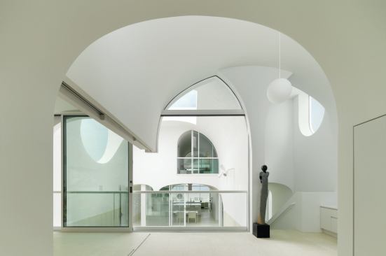 The limited, mostly white, materials palette continues throughout: limestone floors inside and out, painted drywall for the interior walls 

and vaults.