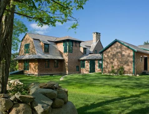 A pair of windows sporting bright hunter green trim flank the top corner of a stair tower, adding an unexpected element to this coastal farmhouse that boosts visual interest without breaking ranks with the rest of the design. Project: River Point, South Coast, Mass.; Architect: Albert, Righter & Tittmann, Boston; Builder: Roger Wilkie Builder, Tiverton, R.I.