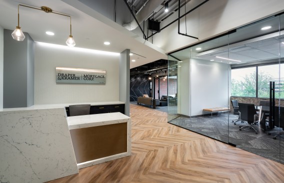 Angles are continued in finishes like the custom reception desk and the herringbone pattern of the floor.