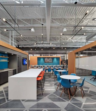 Exposed structure, HVAC, brickwork, metal panel ornamentation, and concrete floor staining are contextual with original architecture and provide an edgy industrial aesthetic.