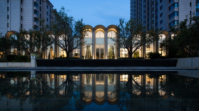 The mirror effect from the reflecting pool completes the arches above.