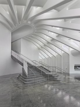 Two grand staircases, one on each end of the oval, lead to the upper floor.