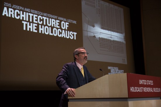 Jaskot&nbsp;delivering the Joseph and Rebecca Meyerhoff Annual Lecture at the&nbsp;United States Holocaust Memorial Museum&nbsp;in Washington, D.C. The image behind him is a viewshed visualization by&nbsp;Chester Harvey that shows what a guard could see from the&nbsp;ramp of Auschwitz-Birkenau.