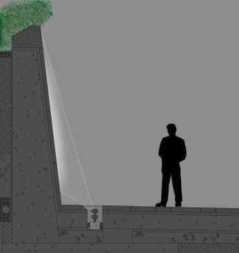 A section at the Inscription Wall. A T5HO  asymmetric luminaire concealed in an in-ground trough along the base of the  wall uplights the carved inscriptions.