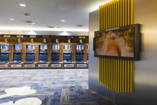 The player locker room inside the Rochelle Athletic Center is designed for the current player, while also recognizing the tradition of the program