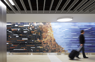 5.%09ROCKFON%e2%80%99s+linear+baffle+ceiling+hides+the+structure+above+and+makes+it+feel+like+a+higher+ceiling.+The+above+structure+was+painted+black+adding+to+this+illusion+of+height.