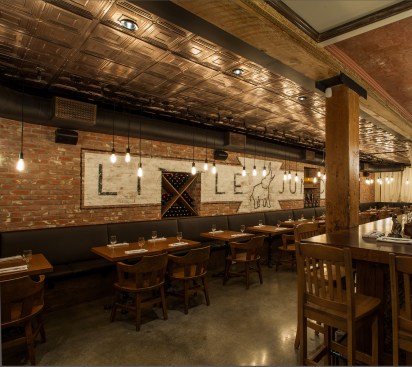 The ground level of this 1902 building was completely stripped down and remade, creating the amtosphere of a 1920’s speakeasy, including a solid wood bartop, a “stamped-tile” ceiling, and  vintage-looking “Edison” style lightbulbs.