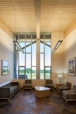 The Welcome Center interior offers views of the surrounding landscaped cemetery.