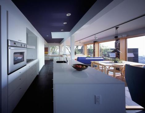 The three companion houses changed the neglected property's density, thus fitting it into the larger community. The kitchen in Salmela's home overlooks Duluth and its harbor.