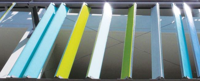 By day the sun saturates the color of the fa&ccedil;ade's glass channels ...