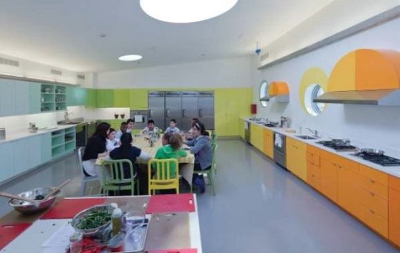 Students enjoy a kale salade they helped to prepare in the kitchen classroom.