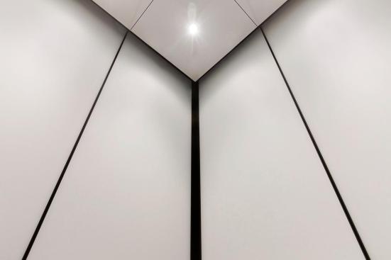 LEVELe-105 Elevator Interior with main panels in ViviChrome Chromis glass with White interlayer and Opalex finish; handrail panels in Fused Graphite with Sandstone finish; Round Handrails in Oil-Rubbed Bronze at the Brandywine Building, Wilmington, Delaware