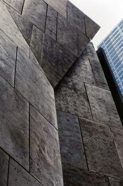The Folk Art Museum's 85-foot fa&ccedil;ade, designed specifically to make '
a quiet statement of independence' from MoMA, which surrounds it on three sides, 
may have led to its undoing, if MoMA director Glenn D. Lowry is to be believed.