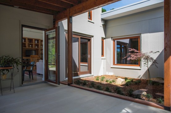 A view through the screened porch to the interior courtyard.
