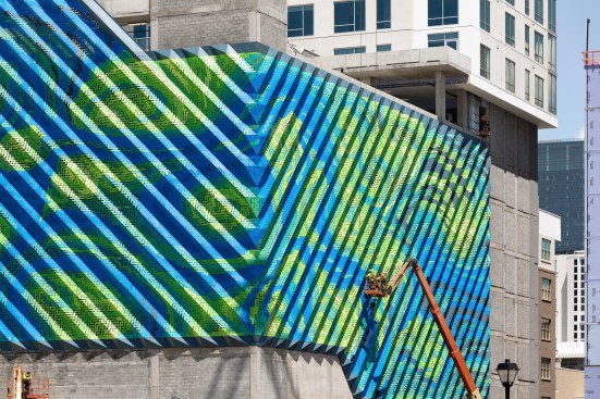 Opposing diagonal folds meet at the corner, while the motif continues across both elevations.