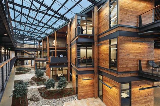 The+architects+clad+the+triple-height%2c+greenery-filled+atrium+in+timber+reclaimed+from+a+warehouse+taken+down+on+the+site.