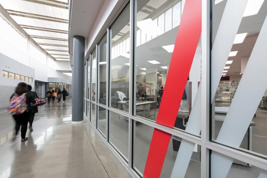 "All 18 academies surround a central space fronted with glass to maximize transparency... Strolling down this main corridor, one can view students engaging in a variety of skills."