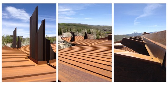 Deep rusted corten steel roof panels are puncuated with exposed structural steel columns.