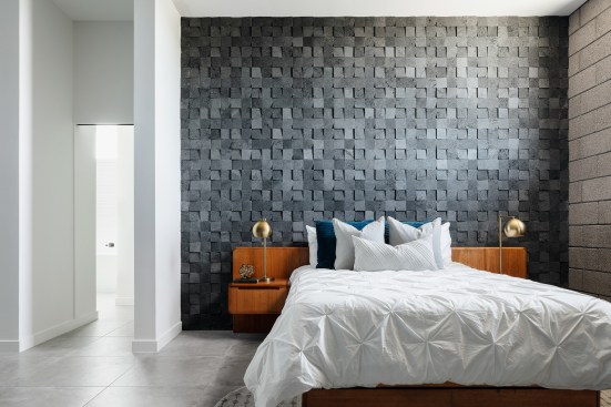 The main bed wall is defined by a 3d lava rock tile.