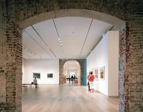 The museum?s new galleries combine pristine spaces for displaying art with remnants of the original structure, including historic masonry walls, hand-formed period Savannah Gray Brick, and original European oak flooring from the site?s 1853 rail depot.