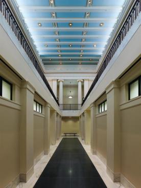 Inside, the first-floor lobby is lined with Doric pilasters.