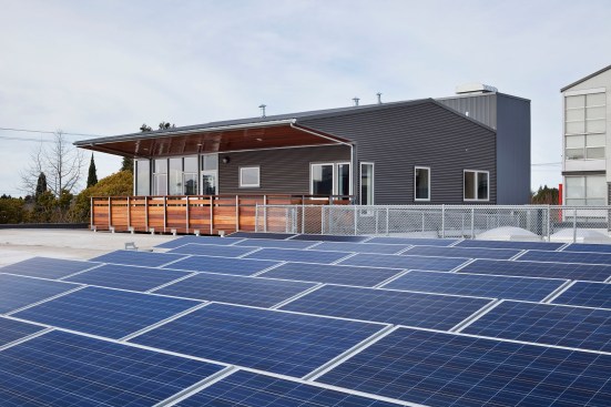 Third floor residence with solar panels in foreground.