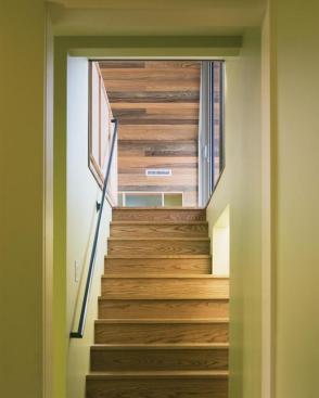 The stairway to the new playroom, inserted into the oversize garage volume.