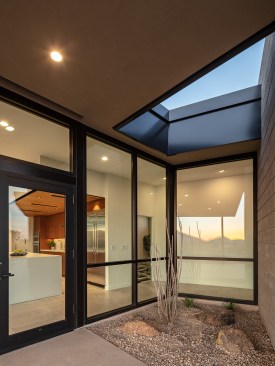A planter with roof opening is tucked into the left-over negative space of the building form.
