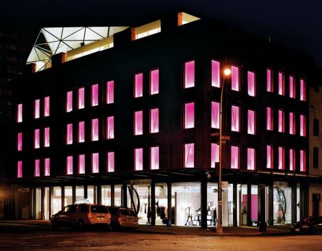 Color-changing LEDs give the building a dynamic presence at night.