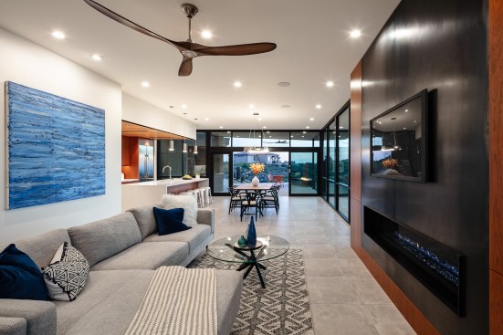 Main living area is floor to ceiling glass with interior shade pockets at the ceiling and exterior sun screens.  Both systems are motorized and controlled by a home automation system.