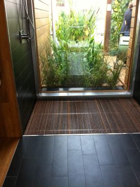 A large window in the bathroom offers a view to the outdoors, while&nbsp;an on-site wetland helps filter and recycle greywater from the shower, clothes washer, and dishwasher.