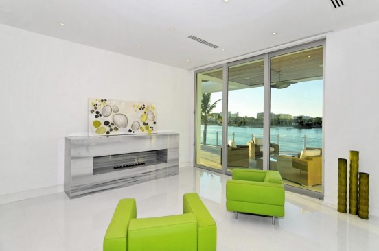 The ripples of the water are mirrored in the plaster wall that cascades three levels down to the floor of the foyer.
