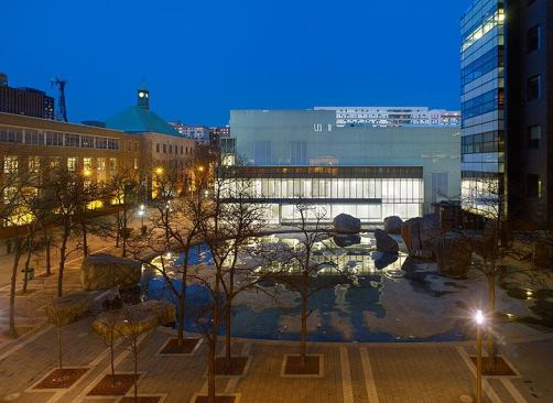 The building at night overlooking the plaza.