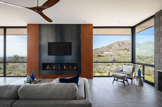 Main fireplace and entertainment wall.  Cherry veneer custom cabinets with oxidized steel fireplace panels.