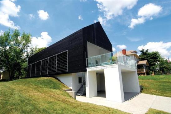 The south face of Studio 804's Prescott Passive House (at left) feature louvers to mediate solar heat gain. The operable triple-pane insulated glazing behind them is part of a natural ventilation system that includes skylights on the north side. A white metal roof helps keep the house cool during spring and summer, when the sun is high in the sky, while a charred Douglas fir fa?ade absorbs warming UV rays in fall and winter.