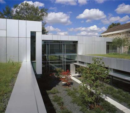 Two-thirds of the office space in the building is at what the architects euphemistically call the courtyard level-or the basement. Maximizing light was essential. "The staff of the foundation reads thousands of pages of grant applications every year," explains Valerio. The workspaces are thoughtful and serene-a cloister for the 21st century. Attention to detail extends to every aspect of the interior environment. A daylight-harvesting system distributes natural light. Occupancy sensors and light control maintain constant levels of illumination and conserve energy whenever possible. A raised floor system permits individual control of HVAC for maximum comfort. Operable windows are used to the extent practical.