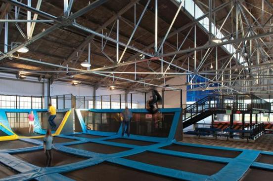 Large field of trampolines in the rear of the space.