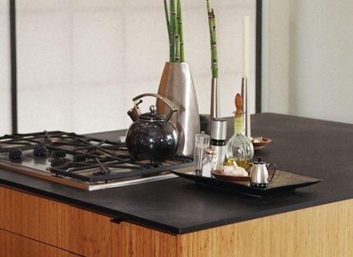 Paneltech Products PaperStone is a surfacing material made from 100% post-consumer paper, resins, and pigments. You can pay full price, or you can visit Green Countertops Direct 
www.greencountertopsdirect.com and, at discounted prices, buy&nbsp;panels left over from completed jobs or discontinued colors. 
www.paperstoneproducts.com.
