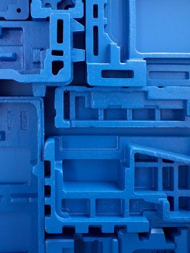 Repurposed formed foam packing materials create a sculptural wall panel and are like finger prints of the copiers. The employees can look at the foam and tell you exactly what copier it came from.  