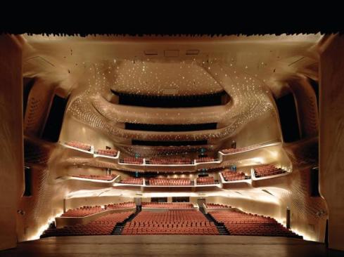 The view from the 3,230-square-foot proscenium stage is dominated by the balconies and by 4,000 LED light fixtures scattered across the ceiling plane.