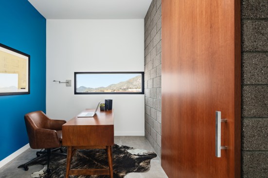 Full height barn door hides the master suite study area.  